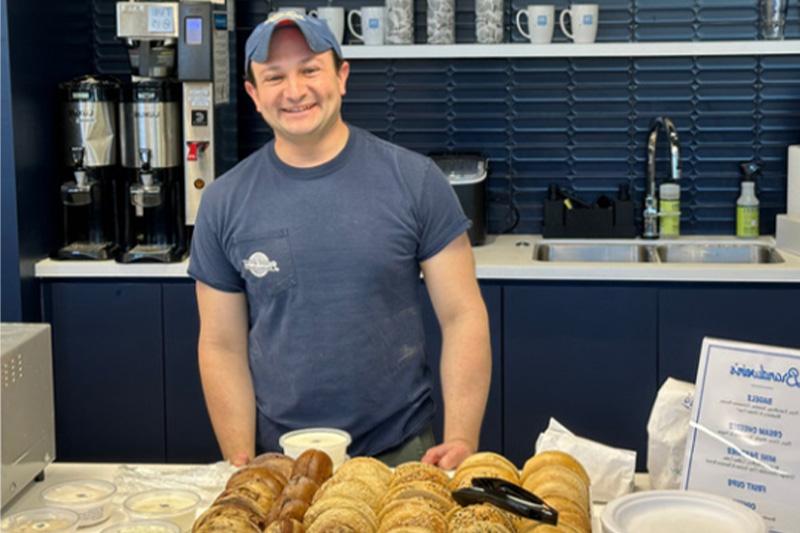 Alex Brandwein standing by bagels.