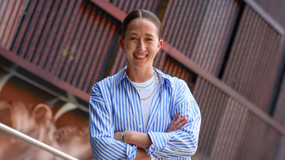 Darcy McFarlane posing in blue button up shirt.