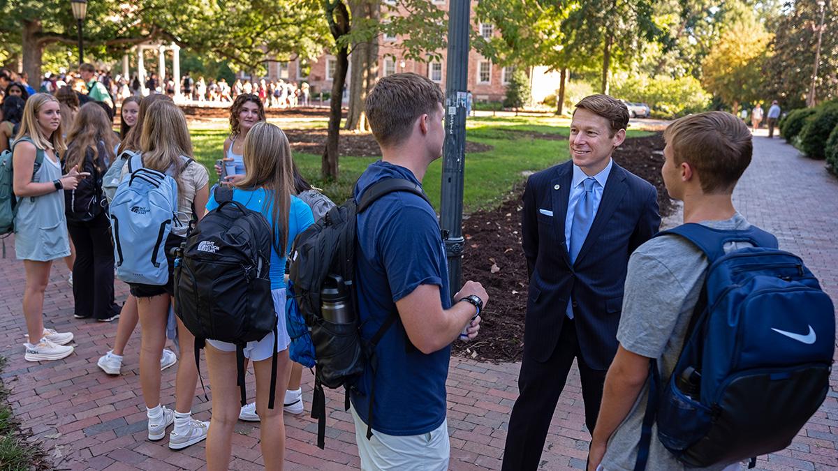 Lee H. Roberts meets with students near the Old Well